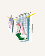 Paper Party Studio Gingham Garden Happy Birthday banner with blue gingham flags, pink letters and daisy accents.