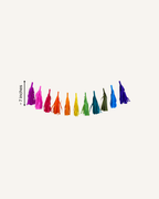 Paper Party Studio tissue paper tassel garland, handmade and strung on a cord for party backdrops.