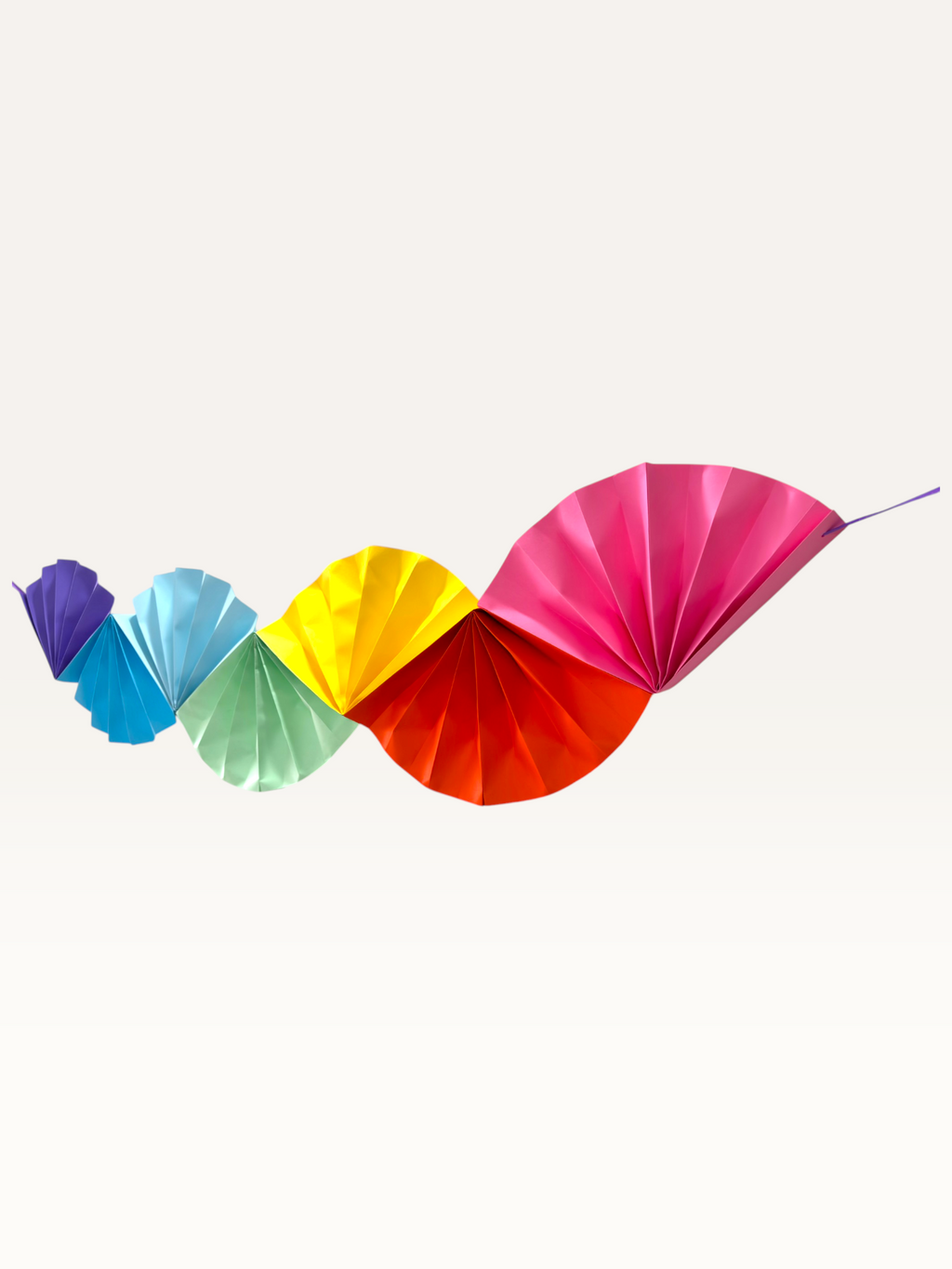 Paper Party Studio Colorwave paper fan garland, a handmade cardstock wall hanging for parties.