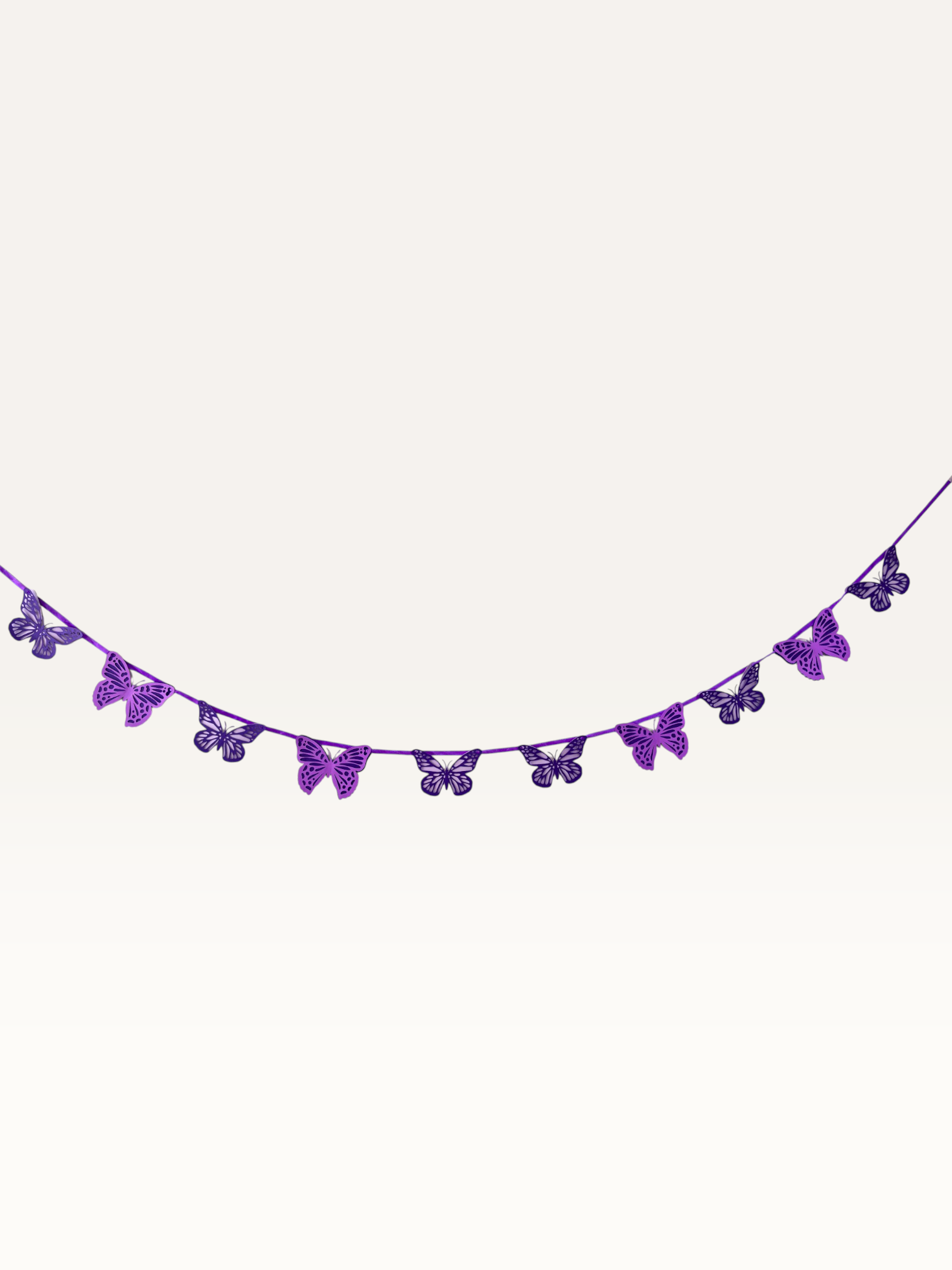 Paper Party Studio handmade paper butterfly garland with intricate cut-out wings, ready to hang.