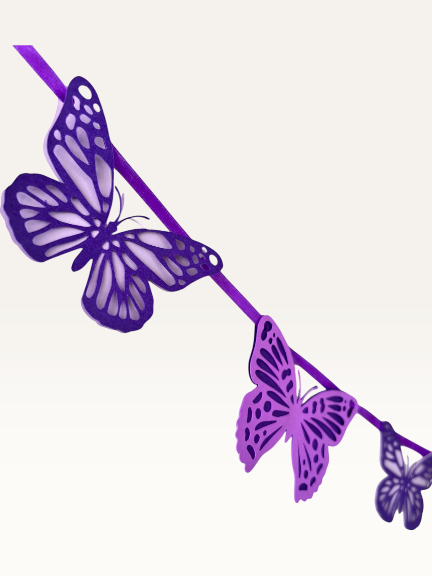 Paper Party Studio paper butterfly wall hanging with delicate cut-out wing detailing.