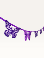 Paper Party Studio handmade paper butterfly garland strung on a cord for party decoration.
