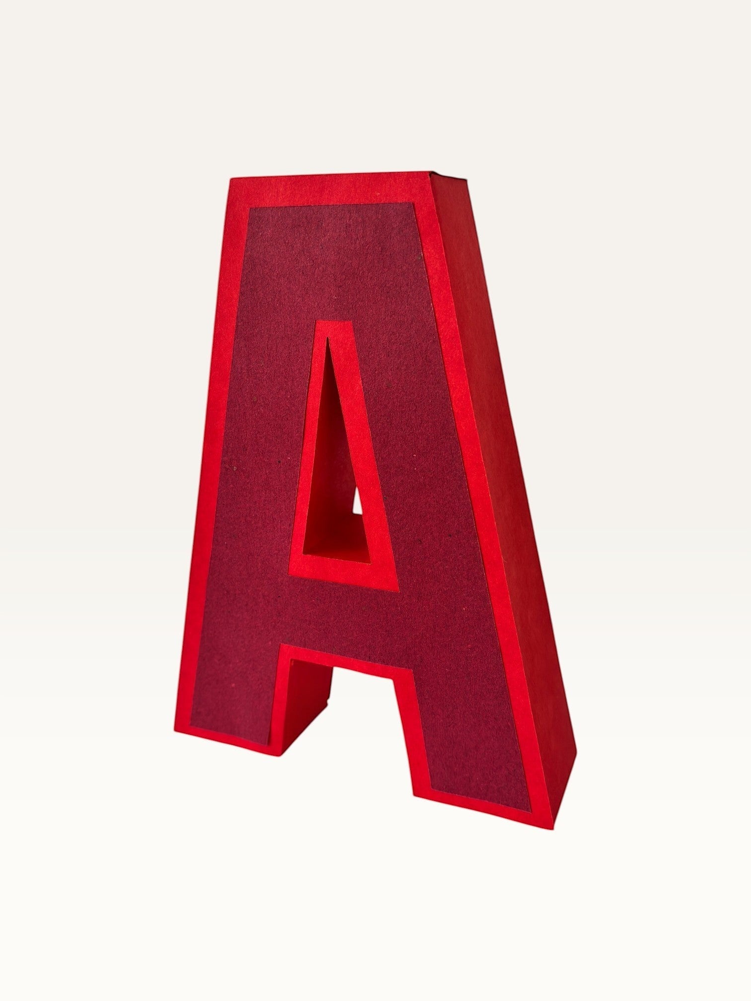 Paper Party Studio handcrafted red 3D letter A made from layered cardstock for party decor and shelf styling.