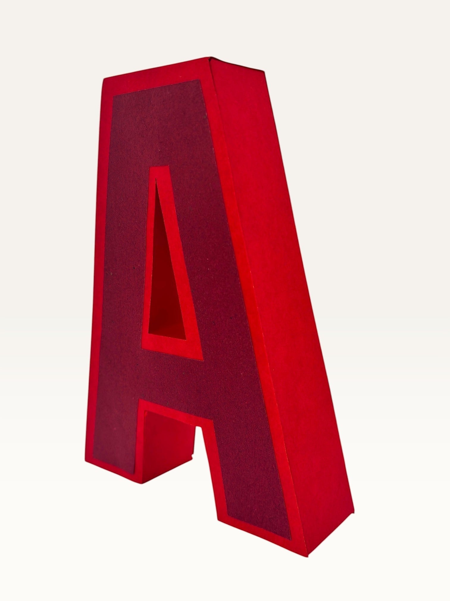 Paper Party Studio handcrafted red 3D letter A made from layered cardstock for birthday and event decor.