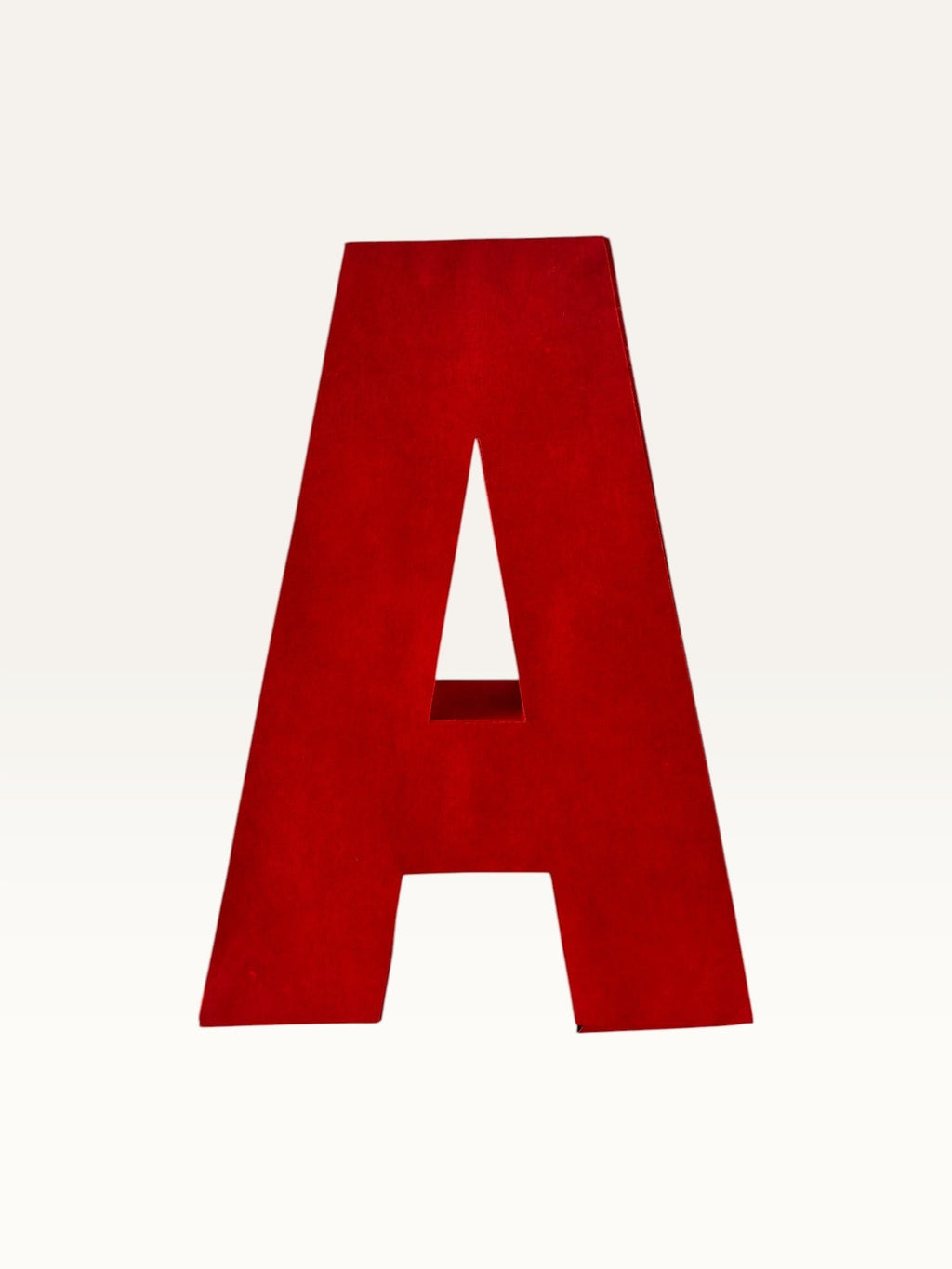 Paper Party Studio handcrafted red 3D letter A made from layered cardstock for party decor and shelf styling.