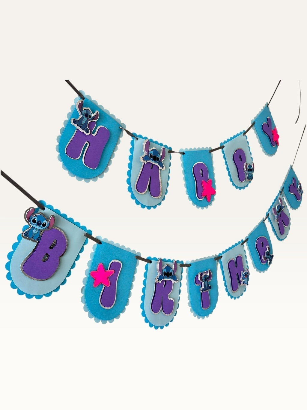 Paper Party Studio blue alien space themed Happy Birthday bunting with purple letters and pink star accents.