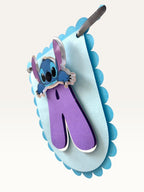 Paper Party Studio blue scalloped cardstock birthday banner with purple letter and cute alien character detail.