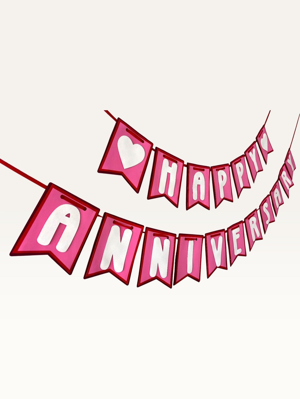 Paper Party Studio pink and white swallowtail heart bunting banner for romantic anniversary celebrations.