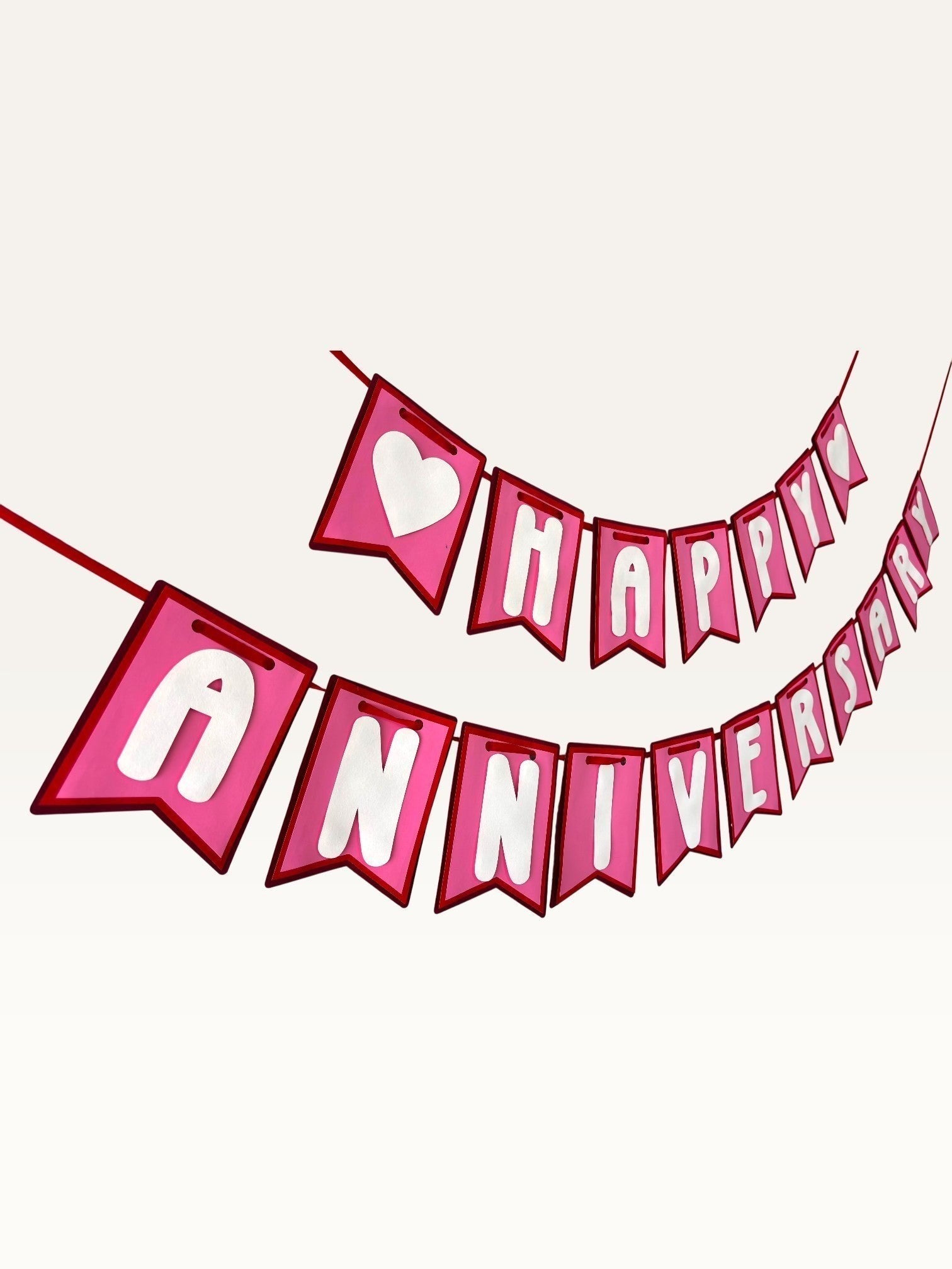 Paper Party Studio pink and white swallowtail heart bunting banner for romantic anniversary celebrations.