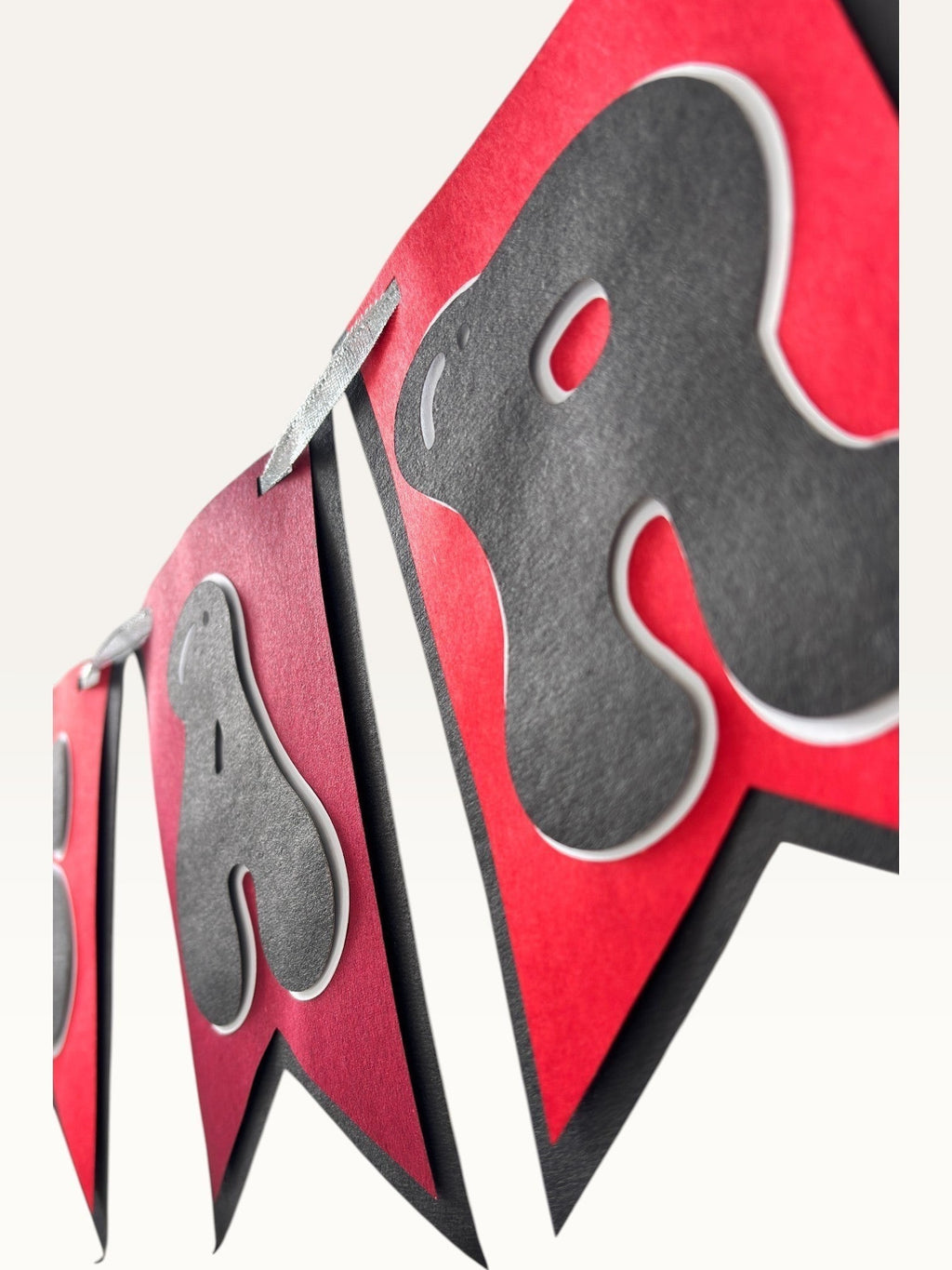Paper Party Studio Happy Anniversary bunting with black bubble letters on red swallowtail cardstock flags.