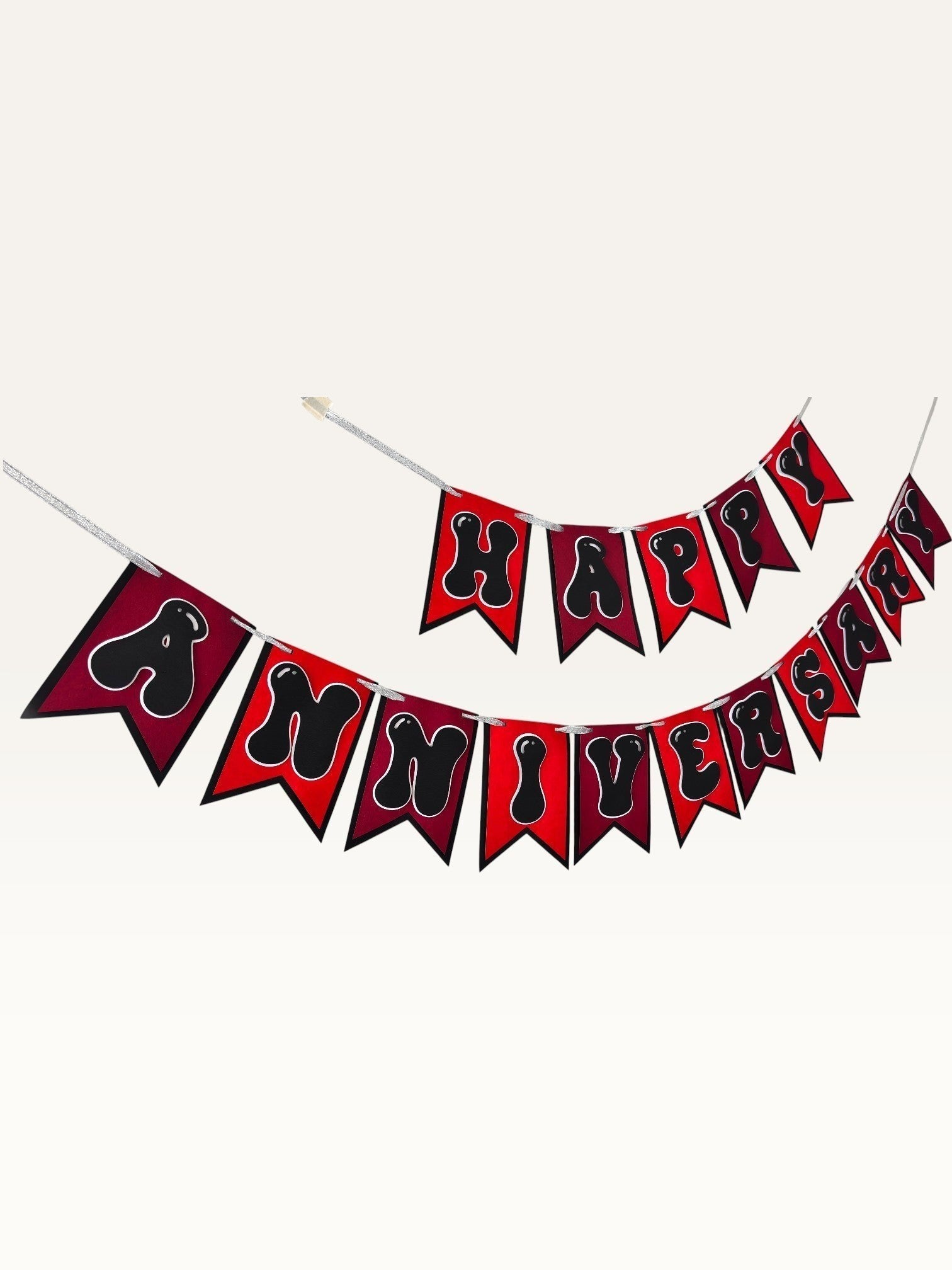 Paper Party Studio Happy Anniversary banner with red swallowtail flags and black bubble letters on silver string.