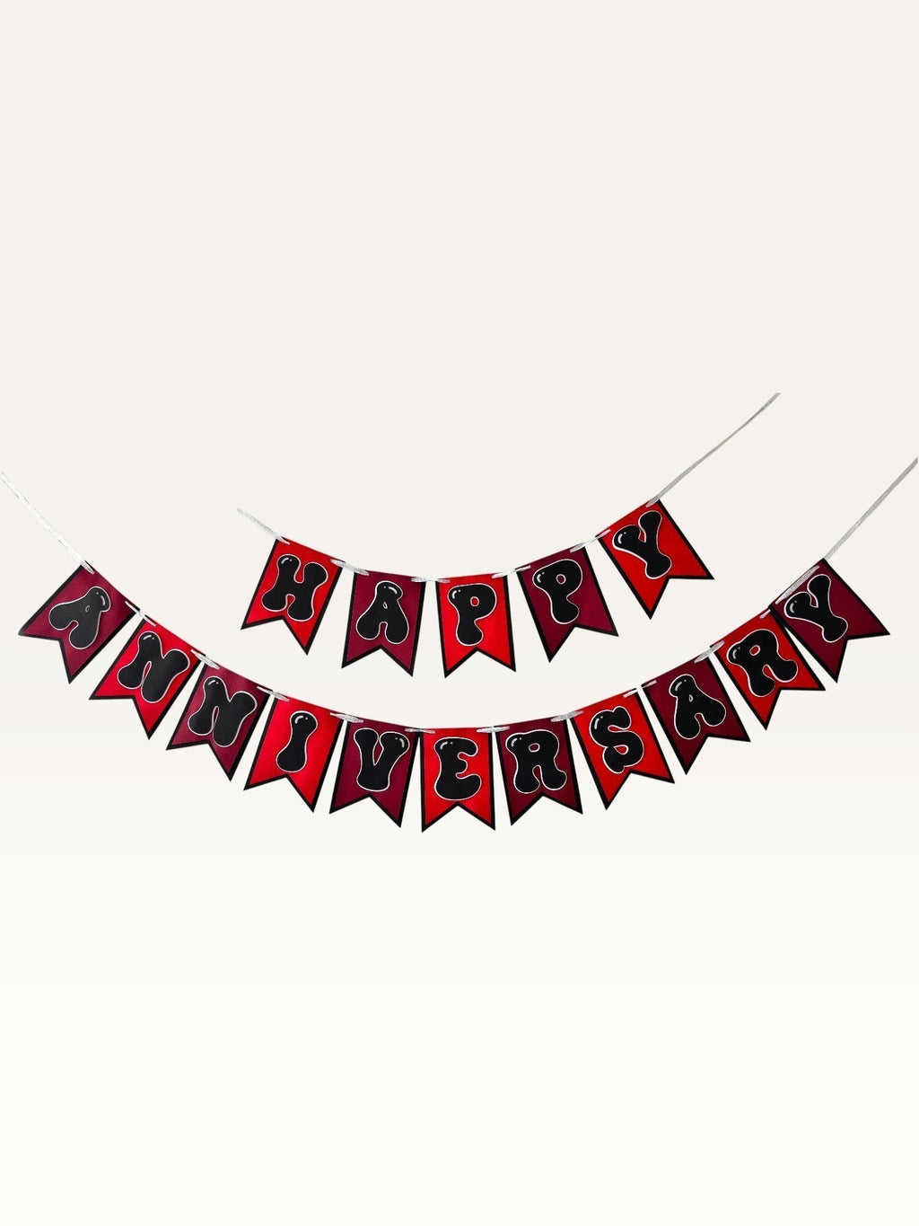 Paper Party Studio Happy Anniversary bunting with black bubble letters on red swallowtail cardstock flags.