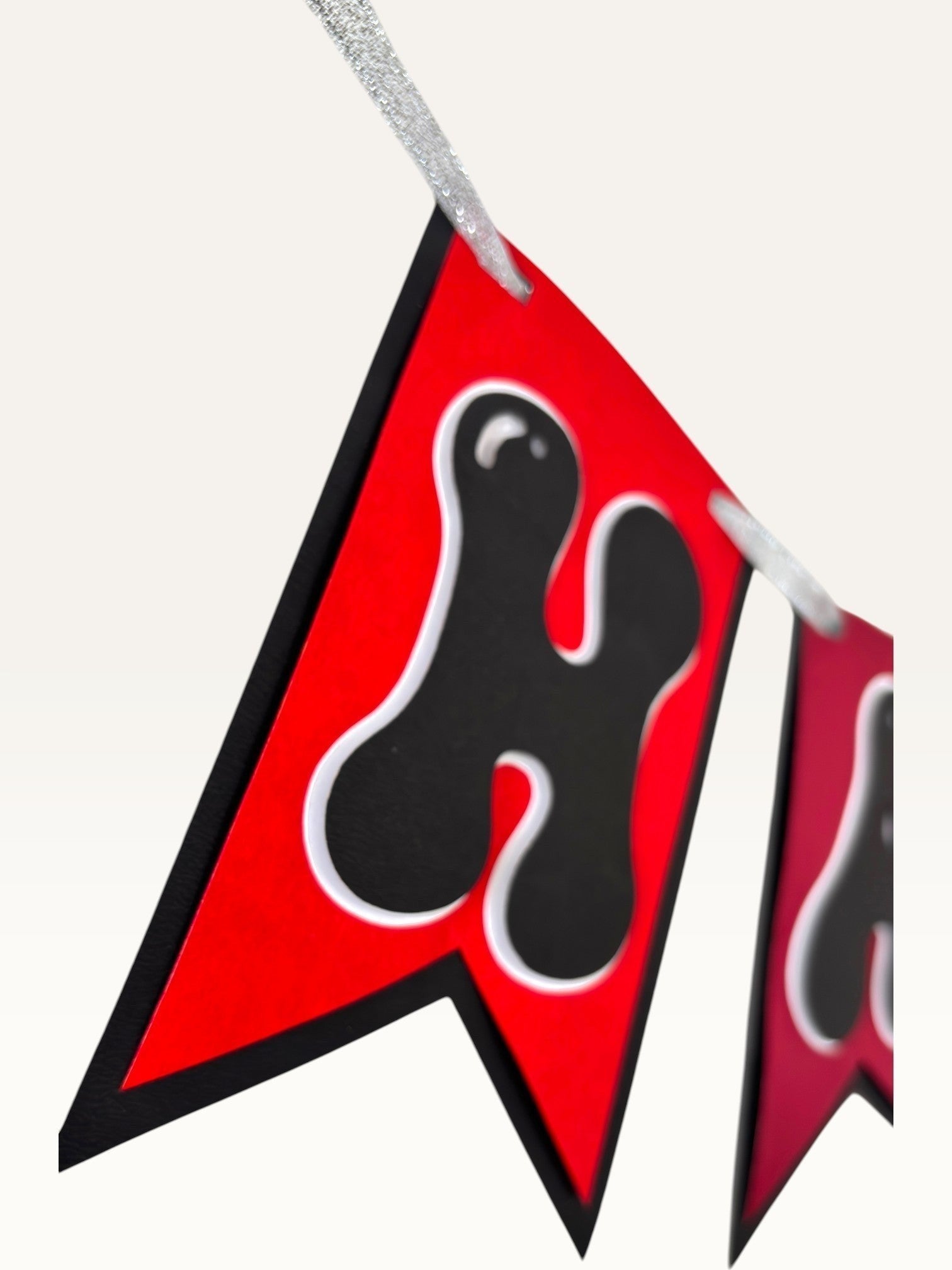 Paper Party Studio red and black swallowtail bunting banner with bubble letter design for anniversary celebrations.