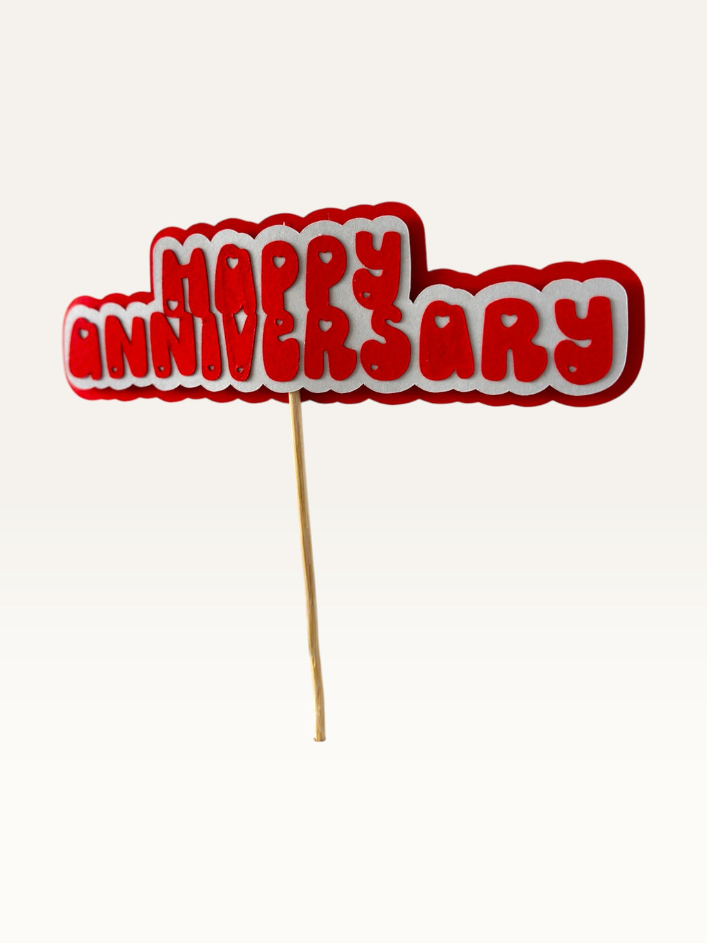Paper Party Studio red and white layered paper Happy Anniversary cake topper with heart cut-outs on a wooden pick