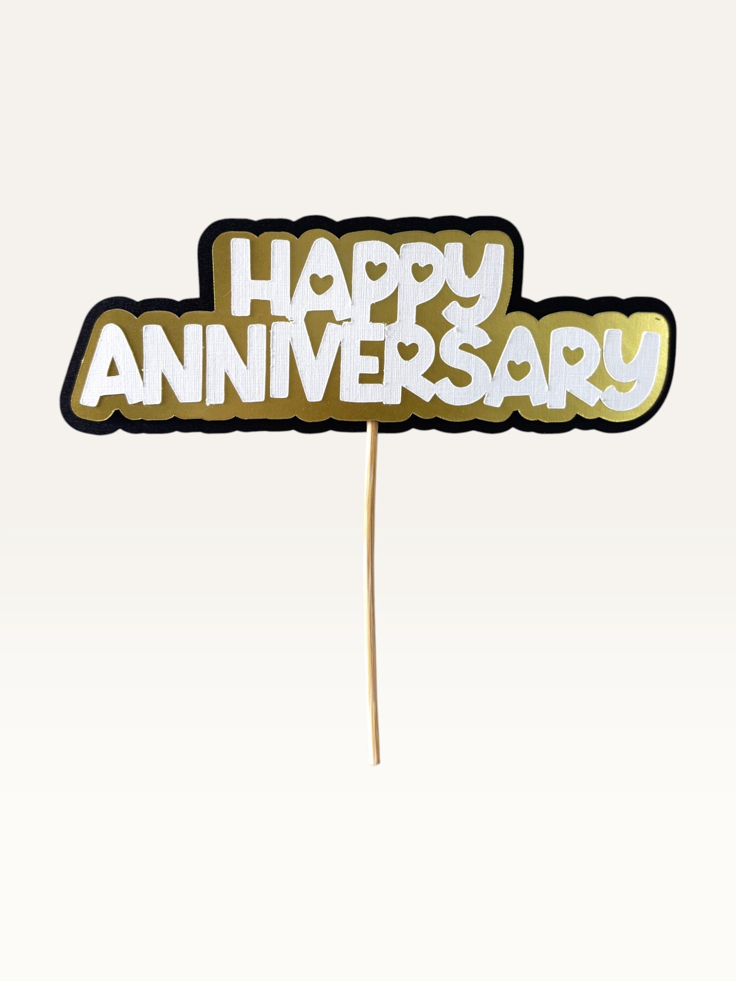 Paper Party Studio Happy Anniversary cake topper with layered white, gold, and black cardstock and heart cut-outs.