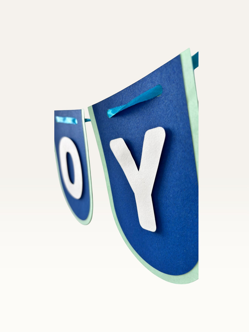 Paper Party Studio navy and sage cardstock Baby Boy banner with white lettering on rounded pennants for baby showers.