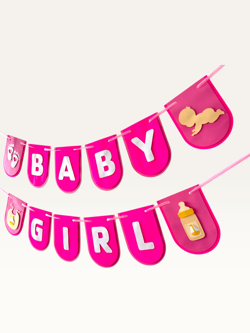 Paper Party Studio hot-pink Baby Girl paper banner with white letters and cute baby motif cut-outs for baby showers.