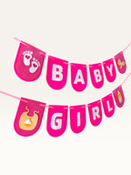 Paper Party Studio Baby Girl banner with hot-pink cardstock flags, white lettering, and cute baby-themed cutouts.