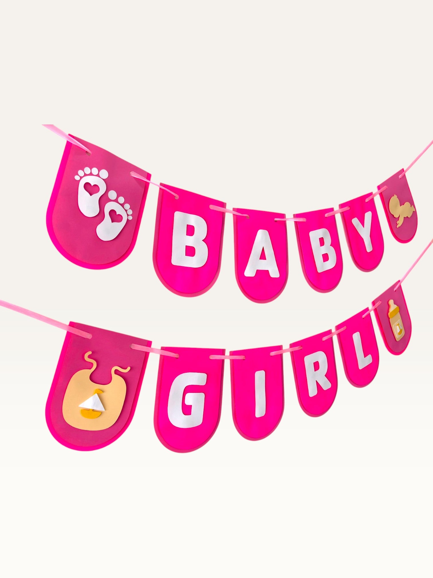 Paper Party Studio Baby Girl banner with hot-pink cardstock flags, white lettering, and cute baby-themed cutouts.