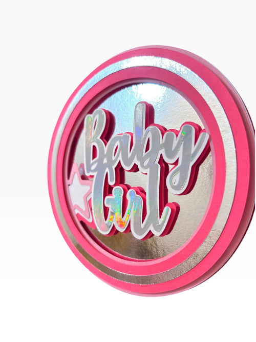 Paper Party Studio Baby Girl holographic layered cardstock cake topper with pink and silver accents and star detail.