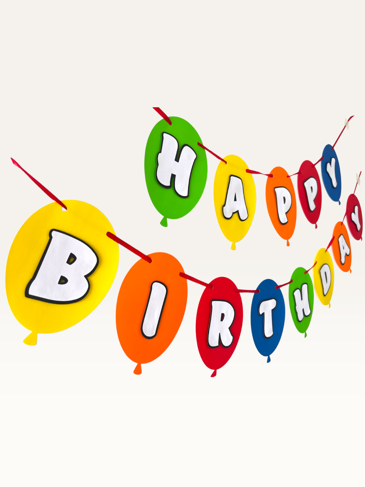 Paper Party Studio multicoloured balloon-shaped Happy Birthday banner with layered white letters on a red string.