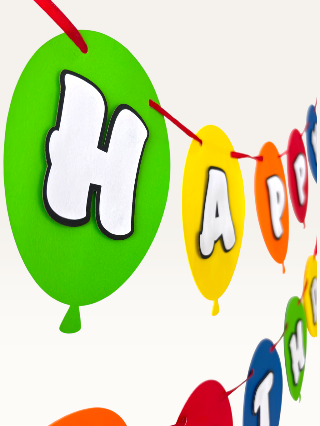 Paper Party Studio Happy Birthday banner with dimensional white letters on colourful paper balloon flags