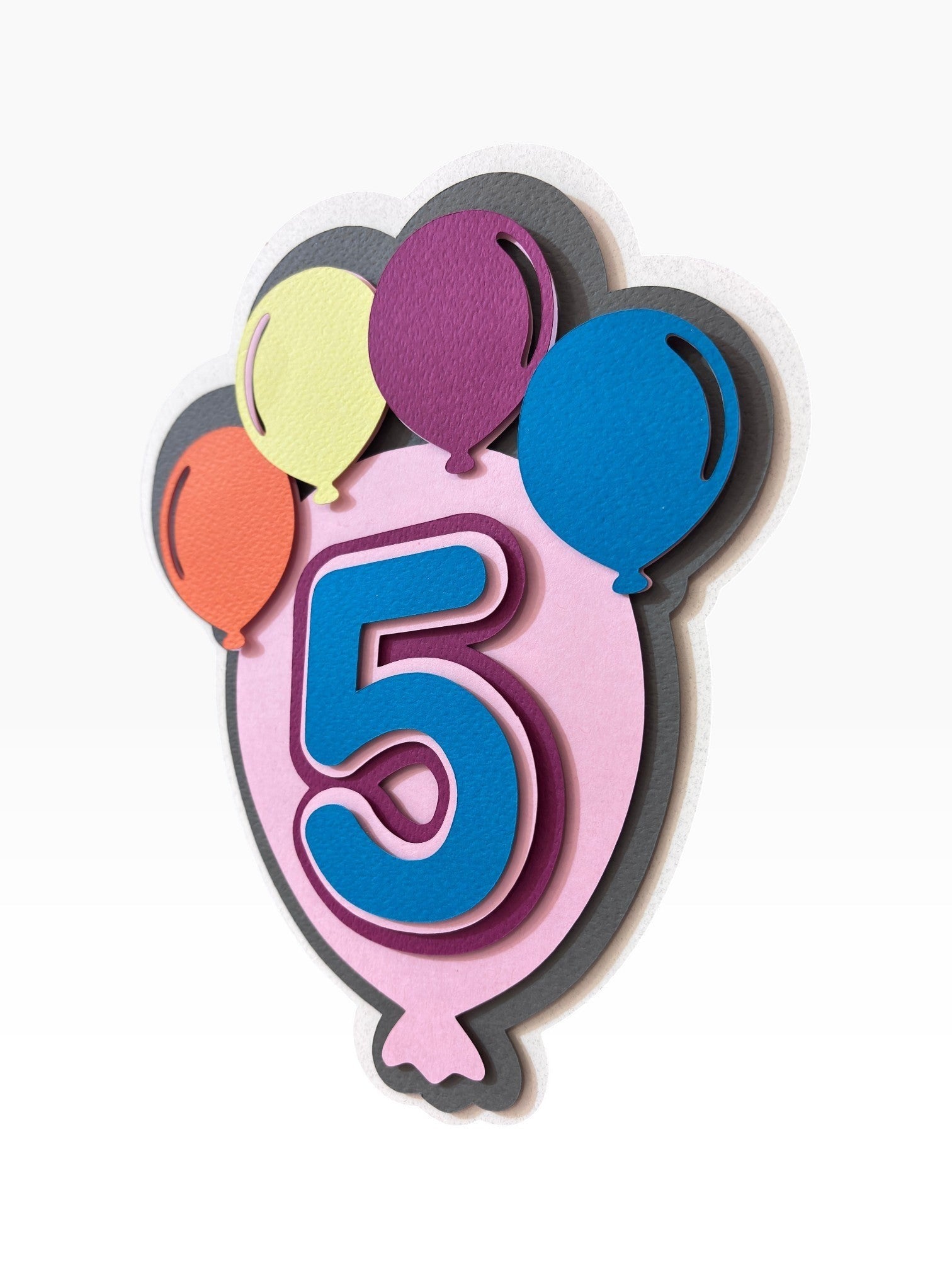 Paper Party Studio layered cardstock balloon cake topper with a blue number 5 and mini balloons in yellow, purple, orange, and blue.