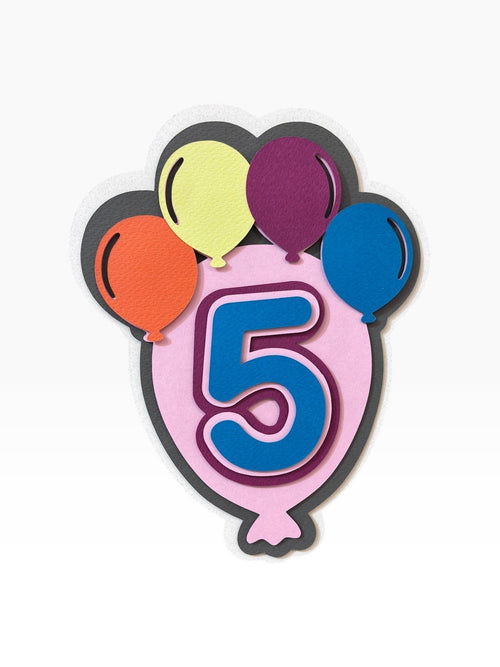 Paper Party Studio layered cardstock balloon cake topper with a large blue number 5 and smaller colorful balloons.