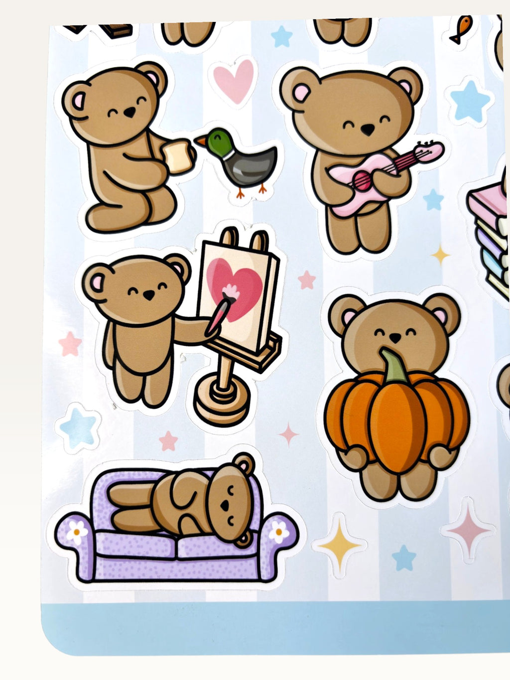 Paper Party Studio glossy sticker sheet featuring cute brown bears painting, playing guitar, and napping on a couch.