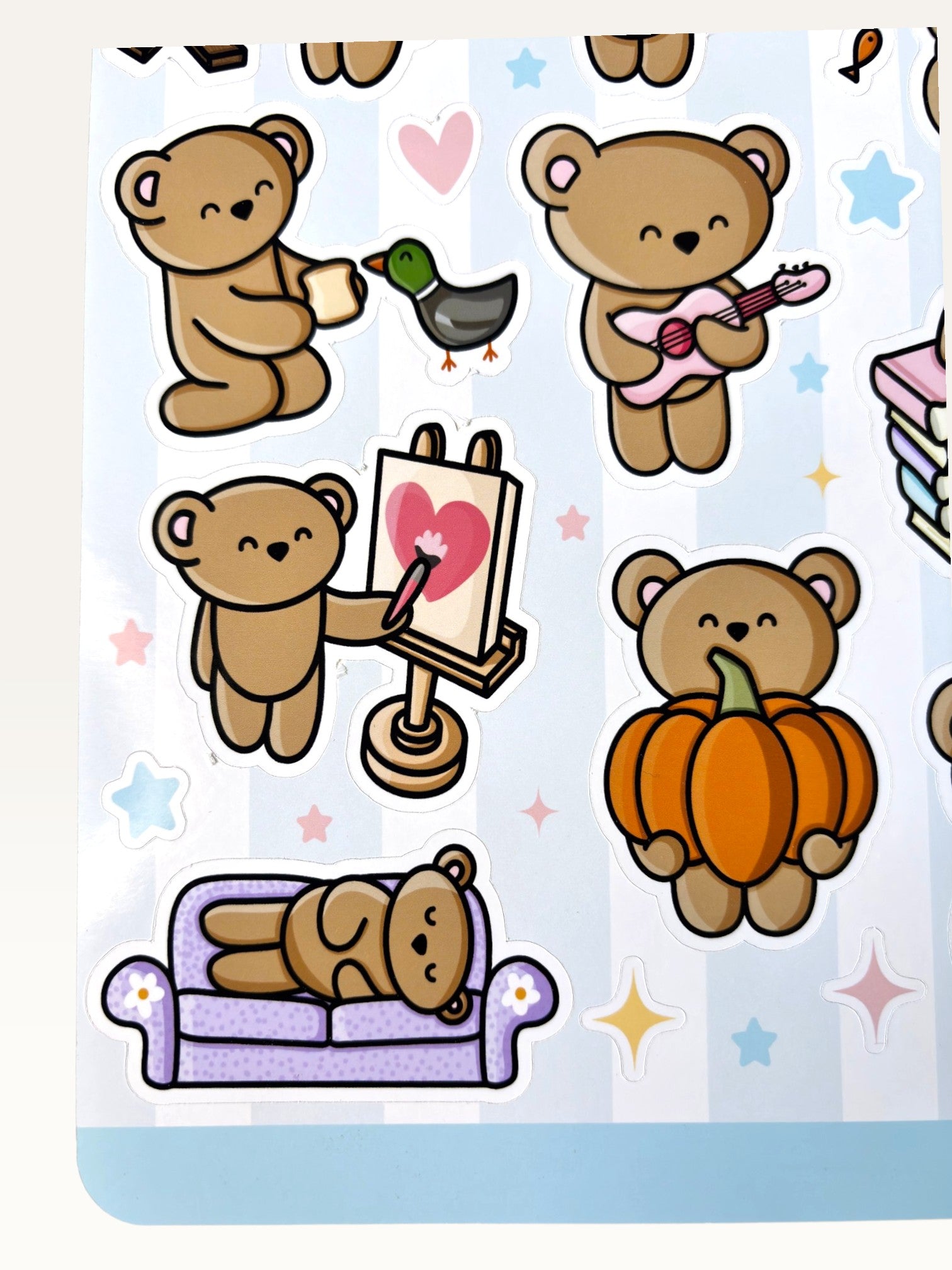 Paper Party Studio glossy sticker sheet featuring cute brown bears painting, playing guitar, and napping on a couch.