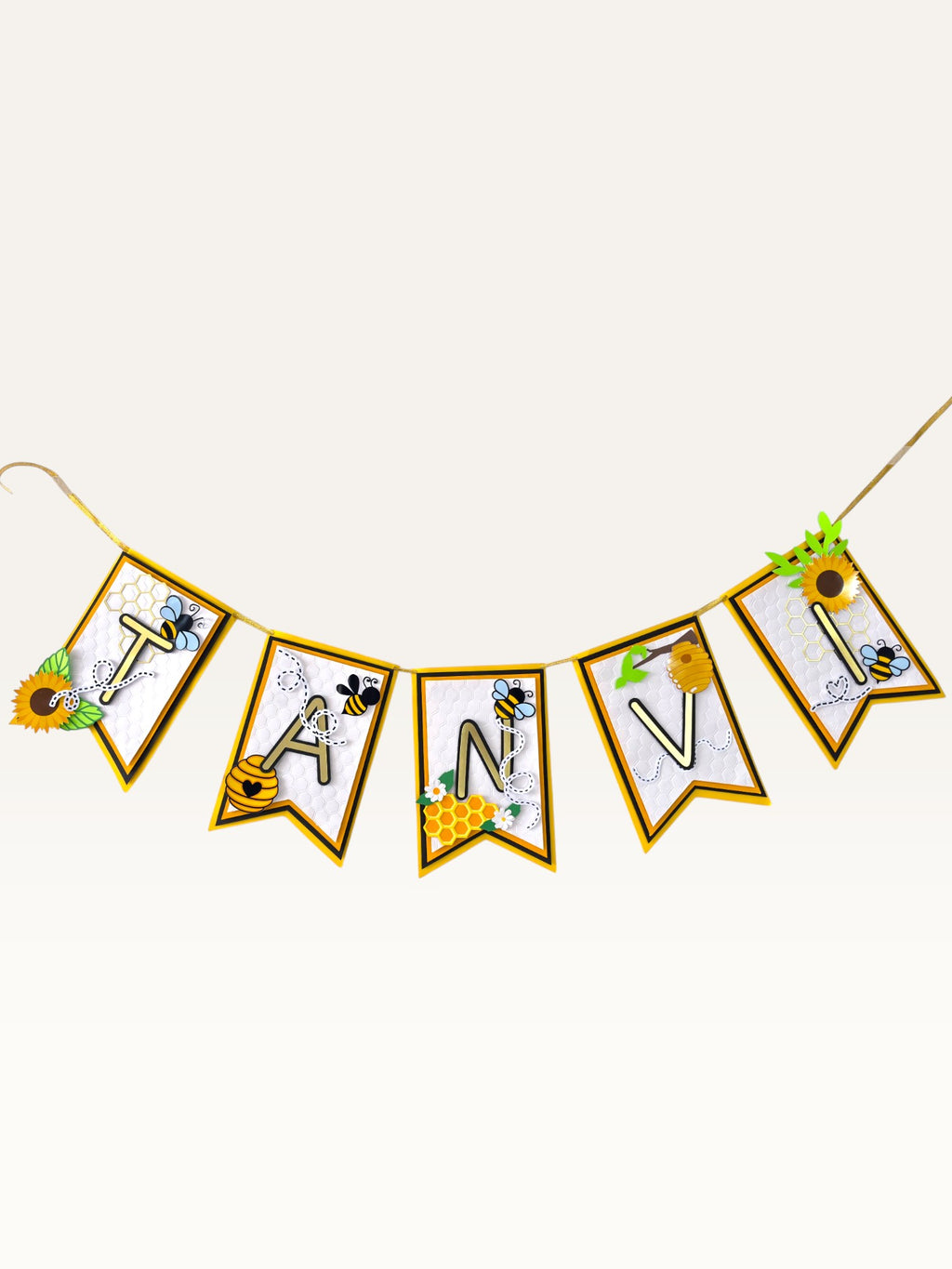 Paper Party Studio personalised bee and honeycomb birthday name banner with gold foil letters and sunflower accents