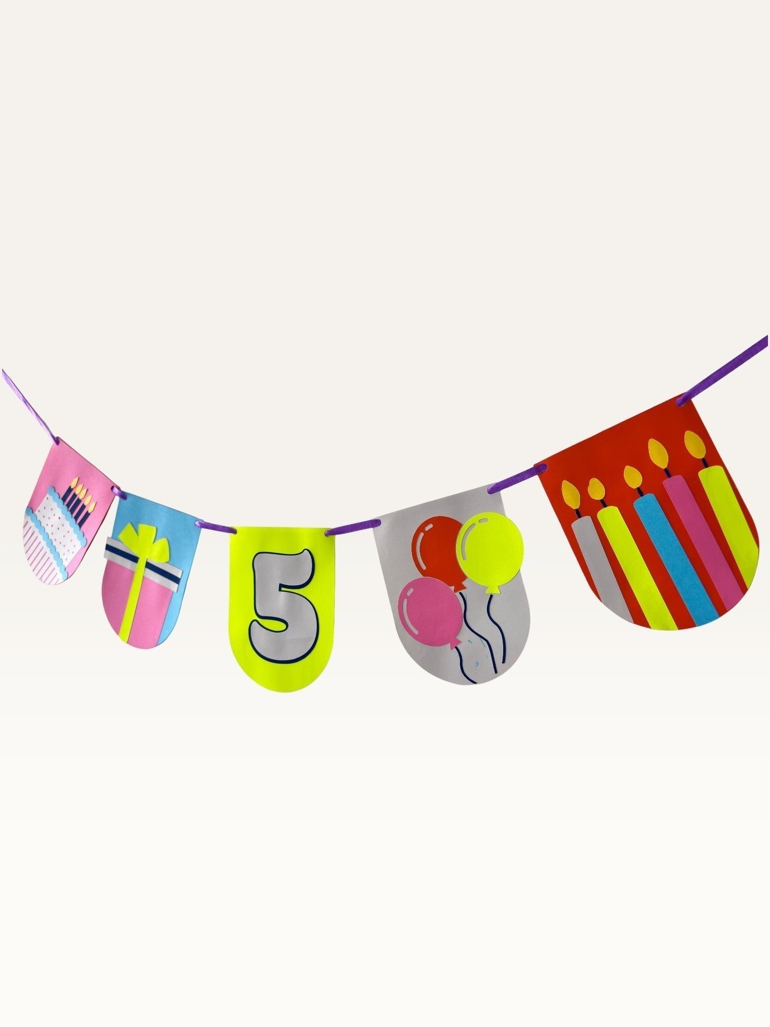 Paper Party Studio custom birthday bunting with colorful cardstock flags featuring cake, gift, balloons, and number 5.