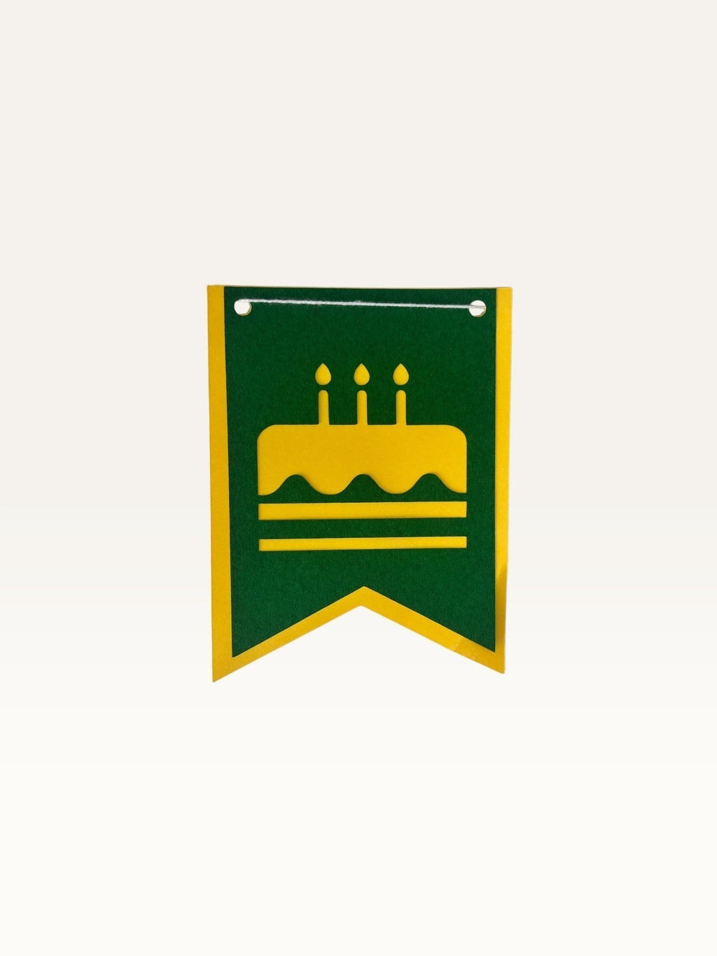 Paper Party Studio swallowtail birthday bunting flag in green cardstock with a yellow cake icon cutout.