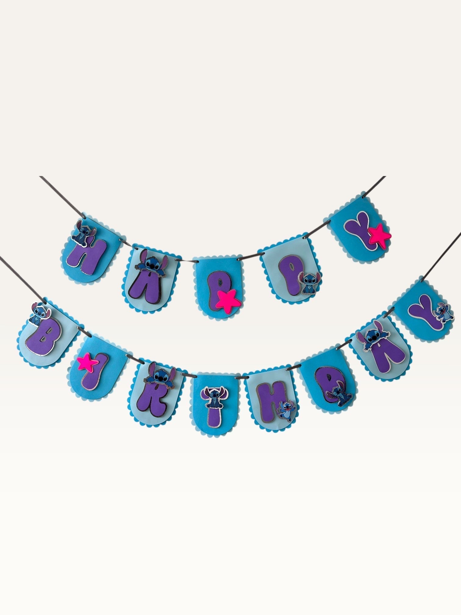 Paper Party Studio Happy Birthday banner with blue alien characters, purple letters, and pink stars on blue scalloped paper