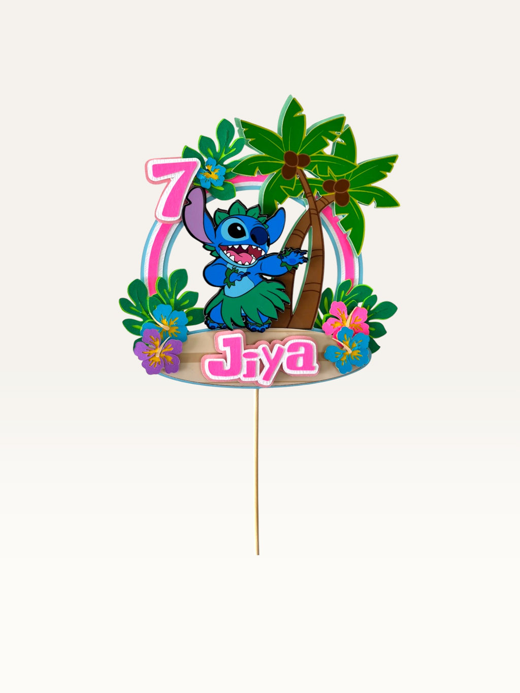 Paper Party Studio personalised blue alien luau cake topper with palm trees, hibiscus flowers, name, and age 7.