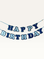 Paper Party Studio navy and sky blue layered paper Happy Birthday banner strung on a cord for party decoration.
