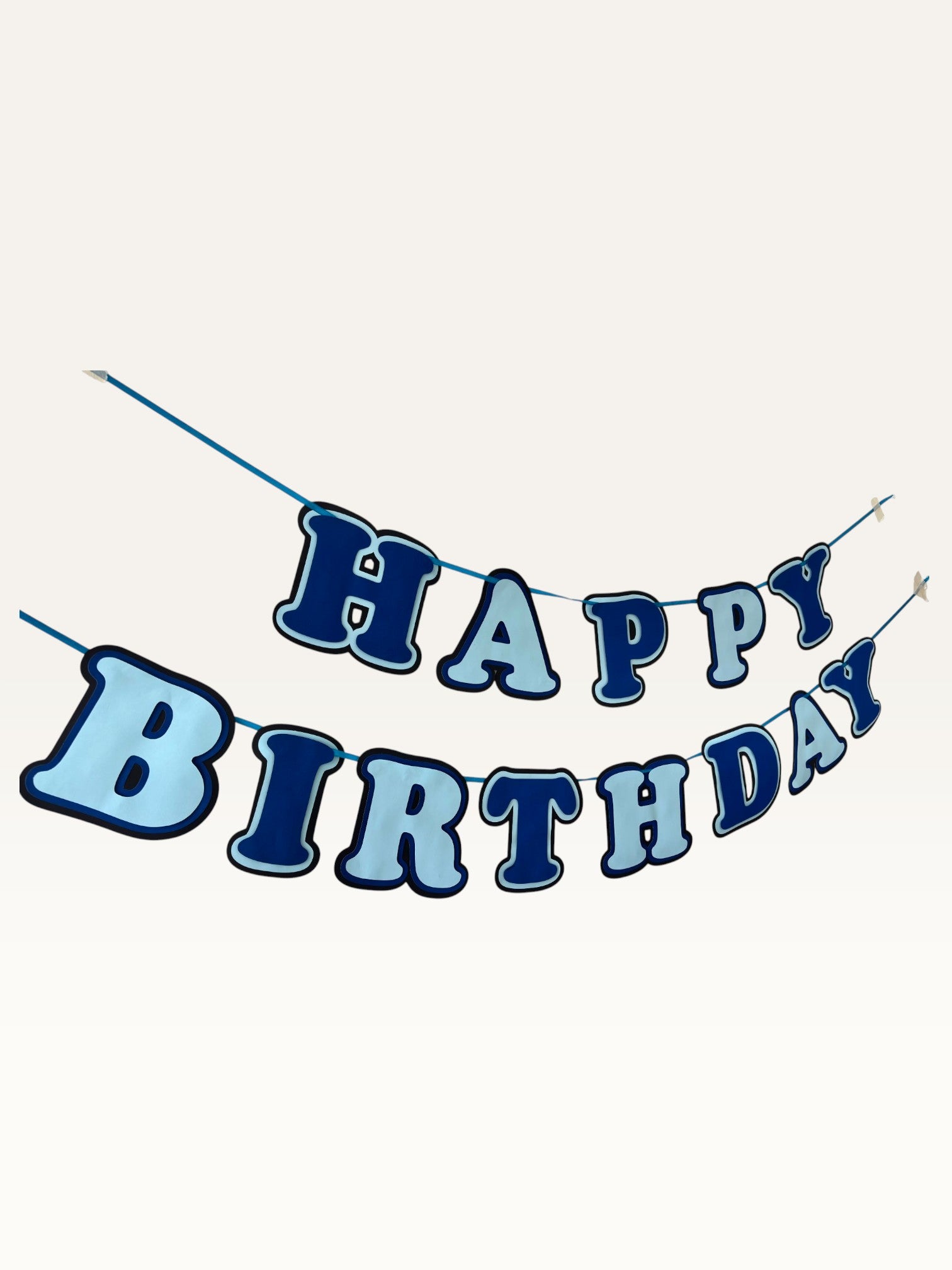 Paper Party Studio navy and sky blue layered paper Happy Birthday banner with dimensional cut-out letters on a cord.