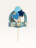 Paper Party Studio blue and gold Happy Birthday shaker cake topper with glitter, sequins, and balloon motifs.
