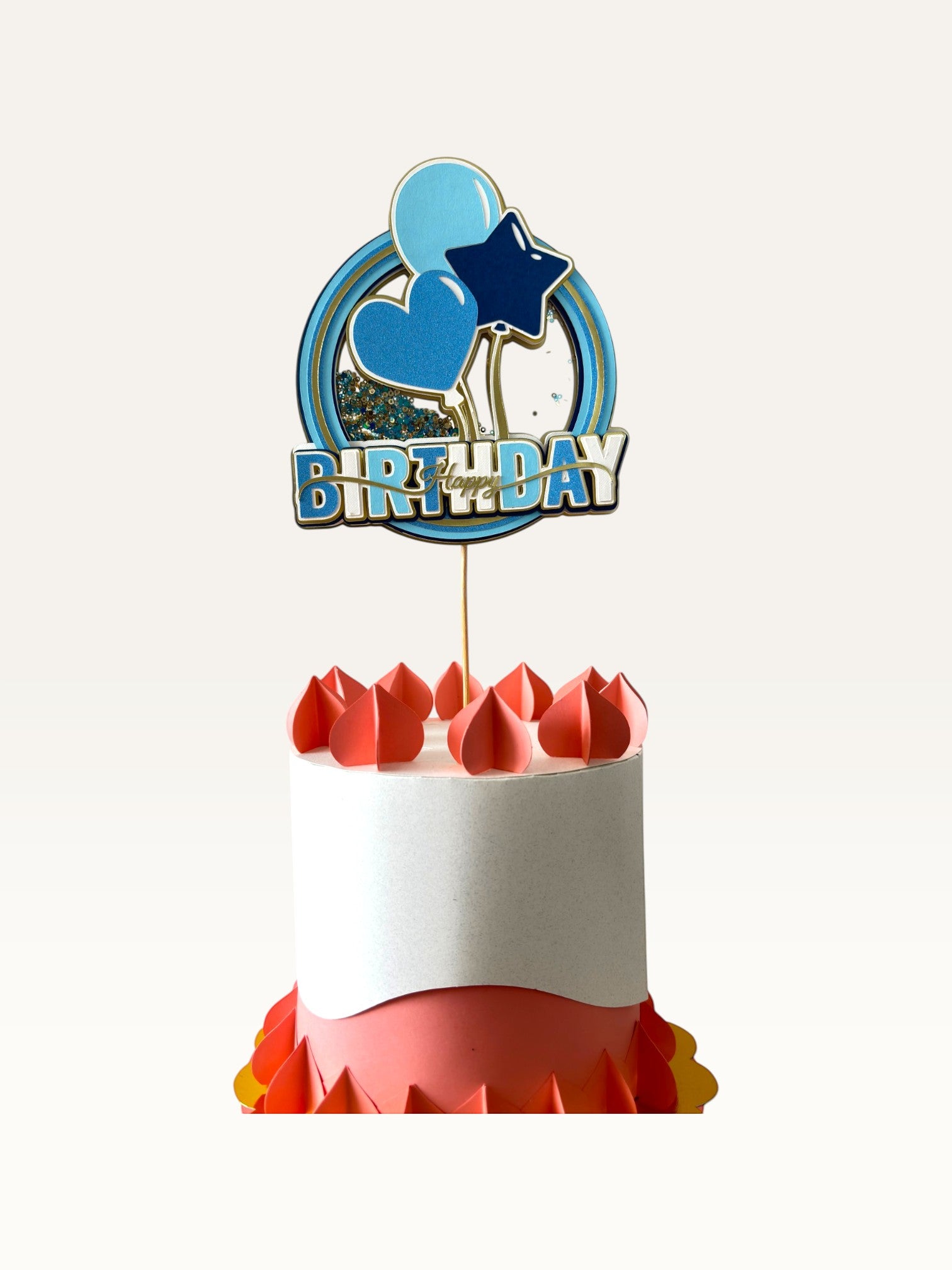 Paper Party Studio blue and gold Happy Birthday shaker cake topper with glitter, sequins, and balloon design.