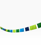 Paper Party Studio blue and green fringe garland with alternating paper tassels for modern celebrations.