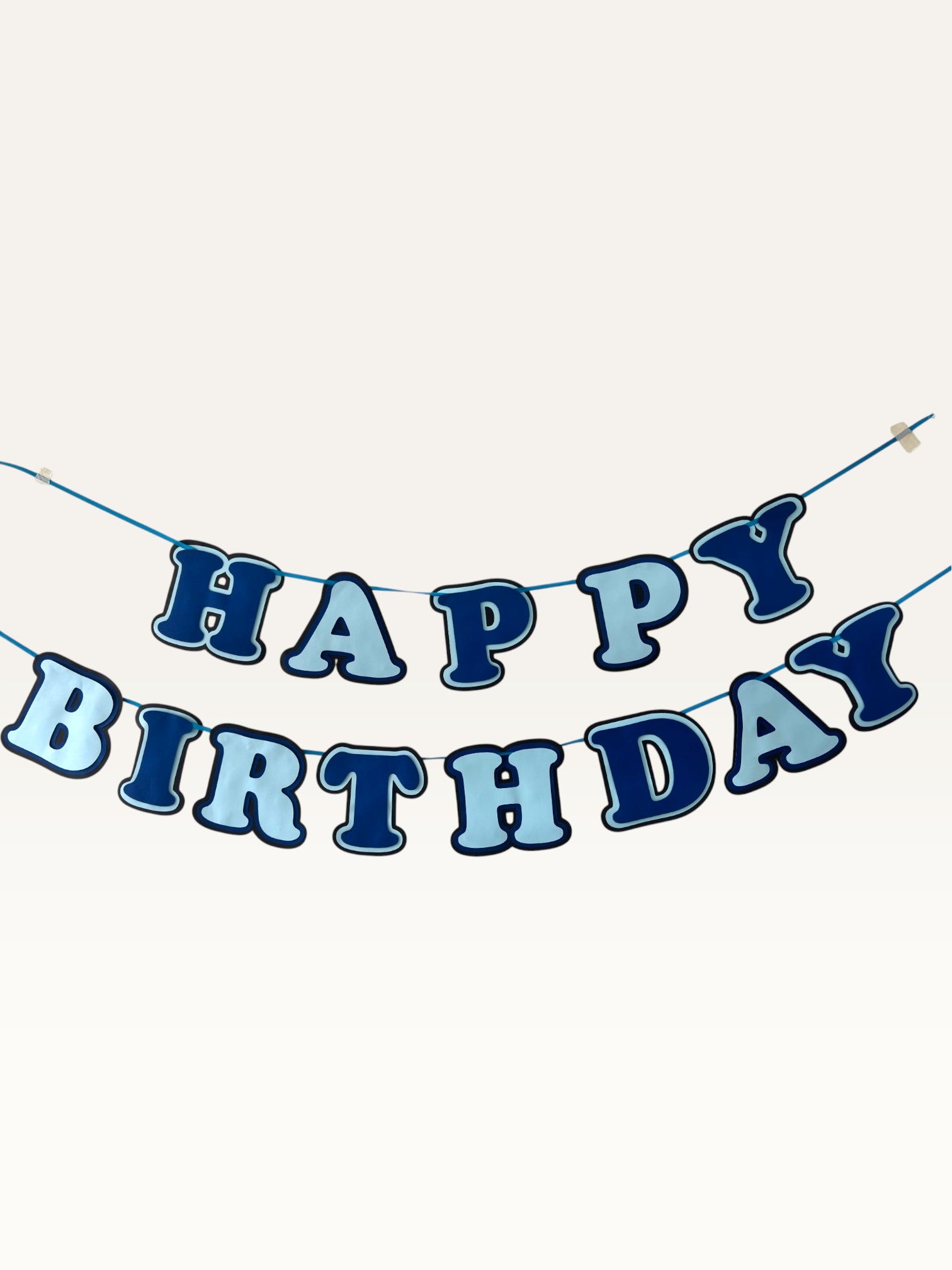 Paper Party Studio blue layered paper Happy Birthday banner with dimensional cut-out letters on a hanging cord