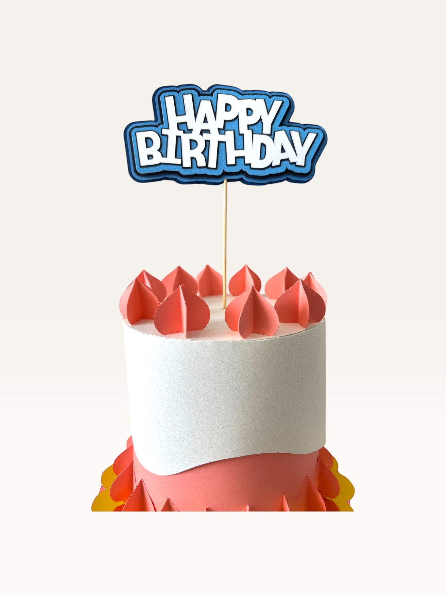 Paper Party Studio layered blue and white Happy Birthday cake topper with scalloped edges on a wooden pick