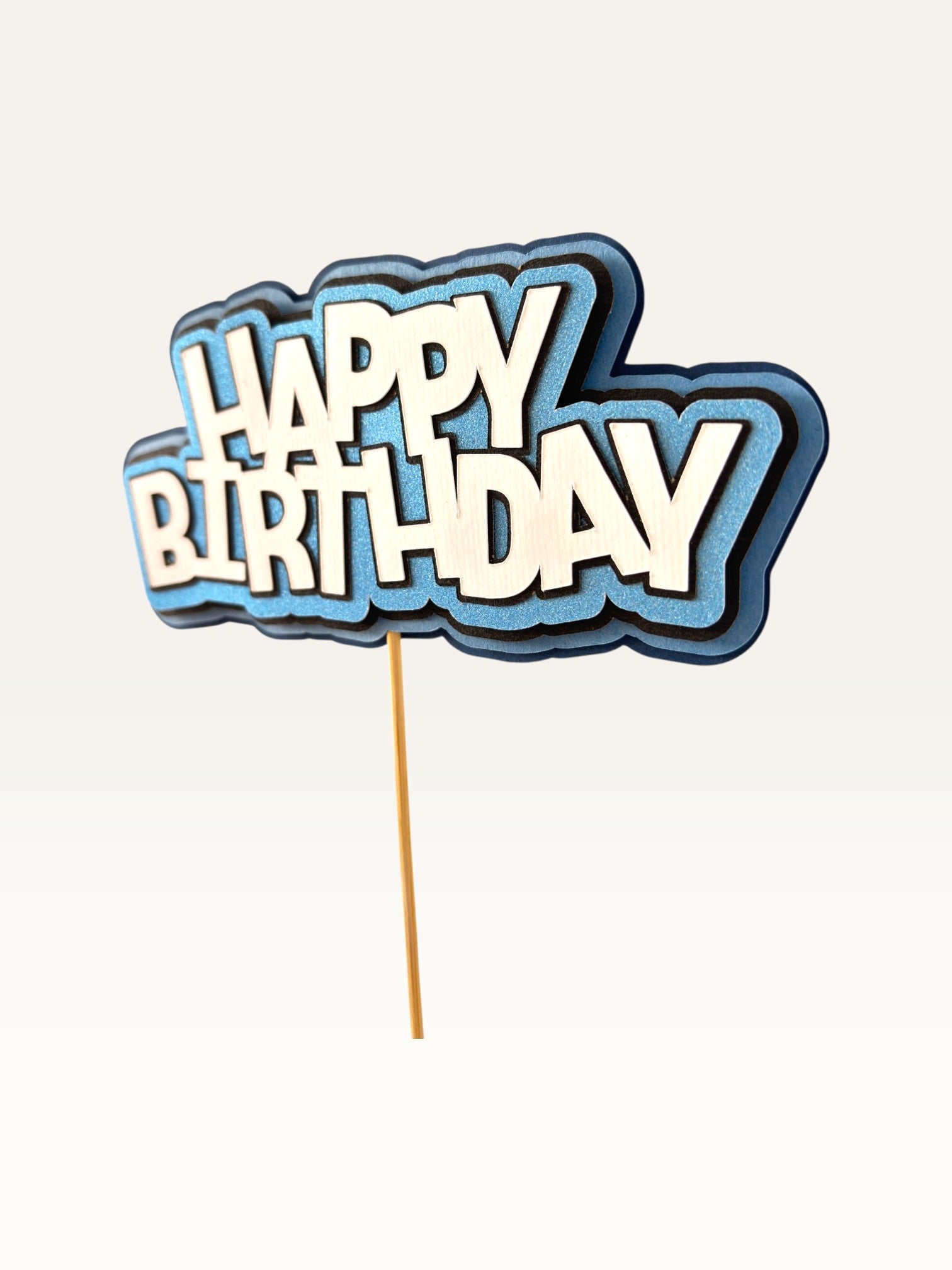 Paper Party Studio layered blue and white Happy Birthday cake topper with scalloped edges on a wooden pick.