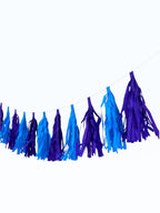 Paper Party Studio handmade blue and purple tissue paper tassel garland for party decorations and photo backdrops.