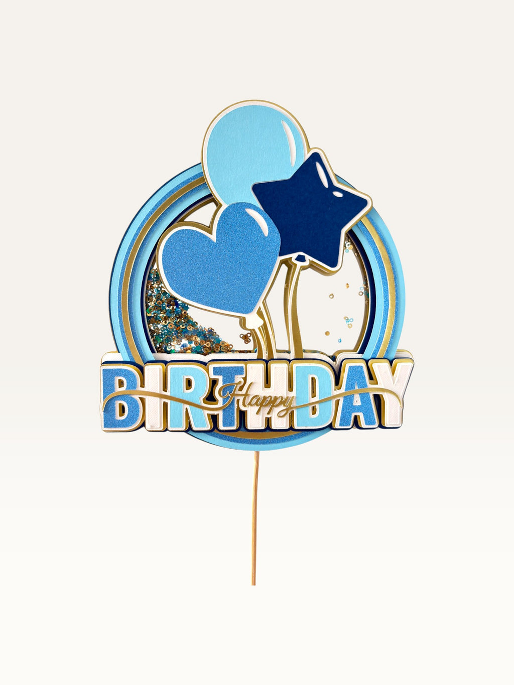 Paper Party Studio blue and gold Happy Birthday shaker cake topper with glitter, sequins, heart, and balloon details.