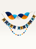 Paper Party Studio blue and yellow birthday party decoration set featuring a fan backdrop and Happy Birthday banner.