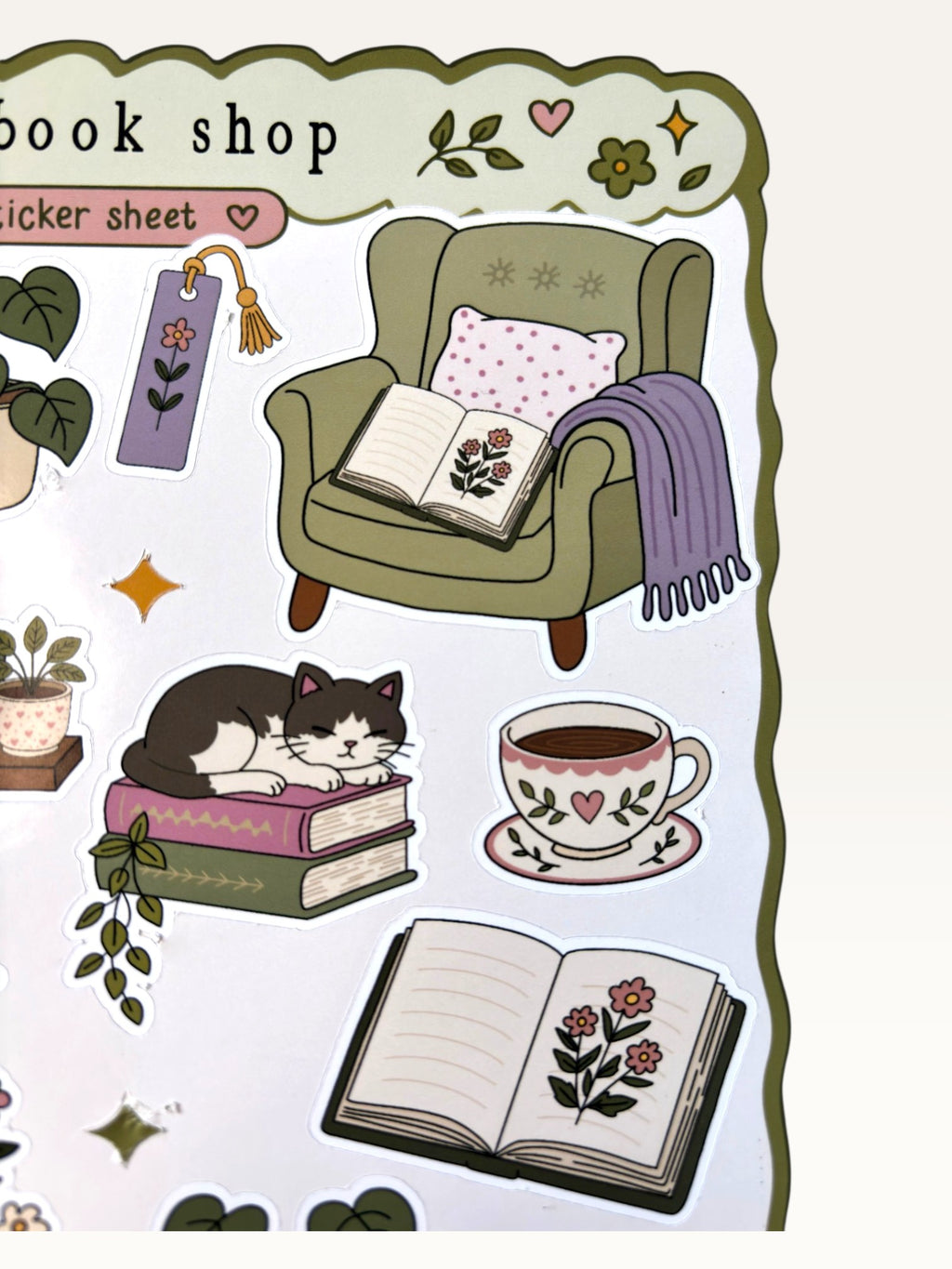 Paper Party Studio glossy sticker sheet featuring cozy bookshop illustrations like a cat, armchair, and open books.