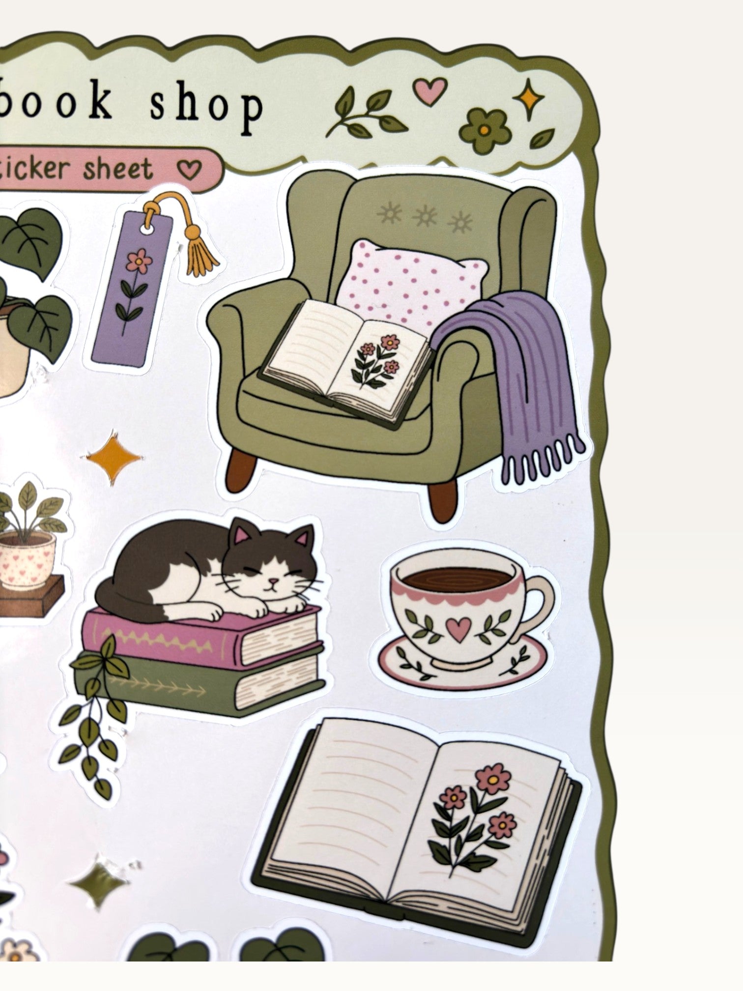 Paper Party Studio glossy sticker sheet featuring cozy bookshop illustrations like a cat, armchair, and open books.