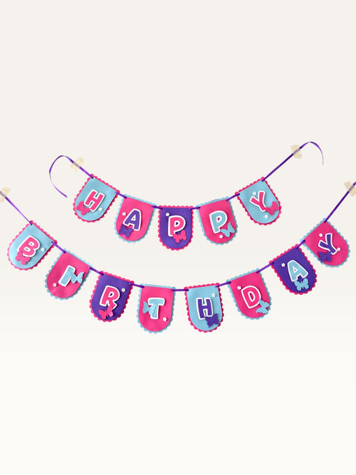 Paper Party Studio Happy Birthday banner with scalloped flags in pink, blue, and purple featuring butterfly accents.