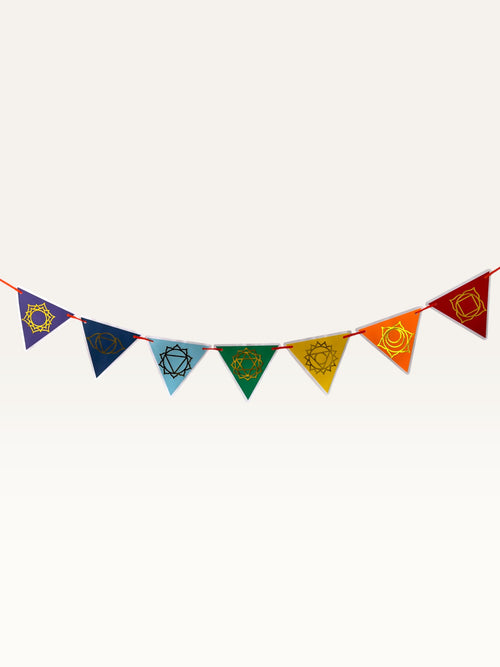 Paper Party Studio seven chakra garland featuring triangular discs with gold foil symbols in traditional colors.